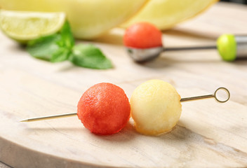 Cocktail stick with melon and watermelon balls on wooden table