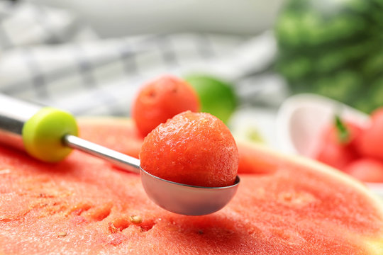 Scoop with delicious juicy watermelon on table, closeup