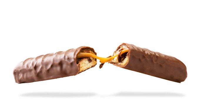 Caramel chocolate bar broken in half on a white, isolated.