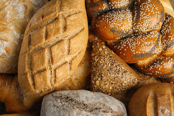 Fresh breads and pastry as background, top view