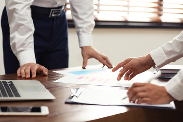 Business trainer and client working at table in office, closeup