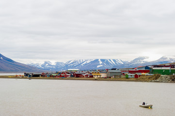 The village of Longyearbyen with mountains and glaciers in the background in Svalbaard, Norway near the Arctic Circle.