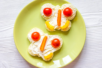 kid breakfast butterfly sandwiches top view on wooden background