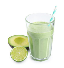 Glass of tasty smoothie with avocado and lime on white background