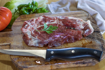 fresh veal chop meat on wood