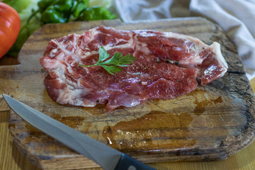 fresh veal chop meat on wood