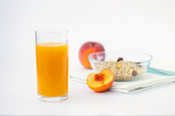 glass of peach juice and fresh fruits with cornflakes isolated on white background