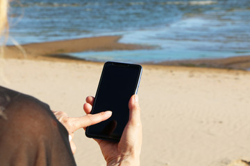 Smartphone in the hand of a business woman