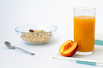 breakfast with fruit and peach juice on white background