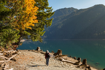 A woman walks along the shore of Baker Lake in North Cascades
