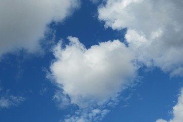 Beautiful heart shape cloud in blue sky, natural background 