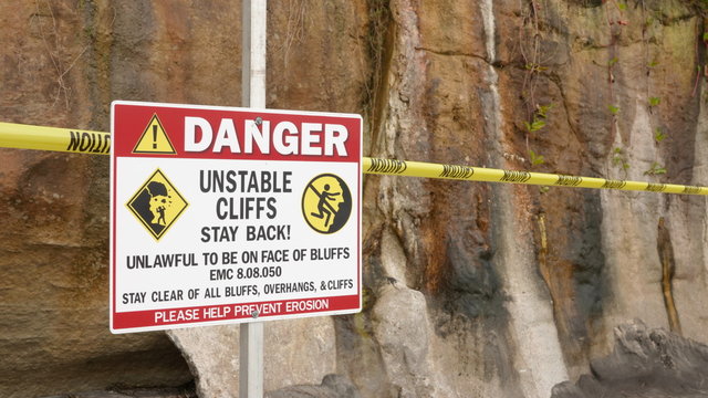 Warning signs for unstable cliffs at site of deadly bluff collapse