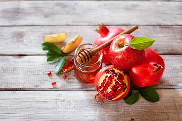 Rosh Hashana concept, jewish New Year holiday with traditional symbols: apples, pomegranate and honey