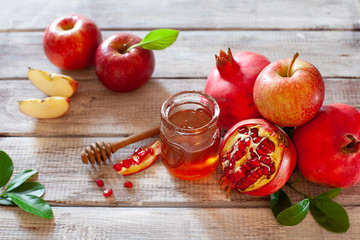 Rosh Hashana concept, jewish New Year holiday with traditional symbols: apples, pomegranate and honey