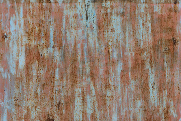 Spots of pink, blue and gray paint on the surface of an old metal sheet. Grunge texture.