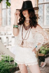 Portrait of beautiful young brunette woman with makeup in white clothing