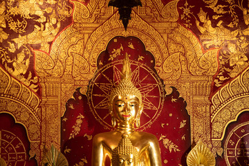 Interior of a Buddhist temple with many golden statues, Chiang Mai, Thailand