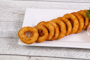 Hot onion rings snack with sauce