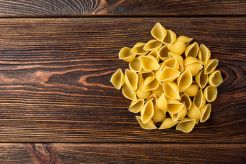 Pasta on dark wooden background.