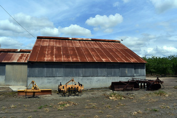 old abandoned farm building with red roof