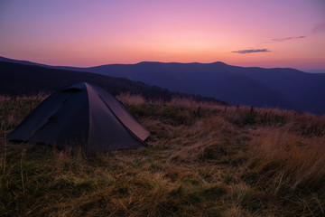 Obraz premium Beautiful mountain landscape with a tourist tent. Carpathian mountains of Ukraine. Holidays in the mountains.