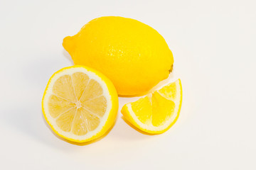 lemons and lemon slices on white background