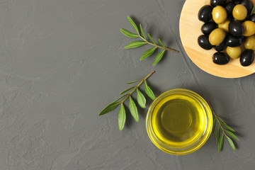 olive oil, green leaves and olives on the table top view.