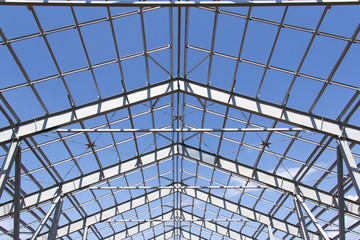 Steel structure of building construction on blue sky background