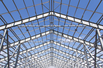 Fototapeta premium Steel structure of building construction on blue sky background