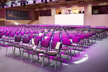 rows of chairs in conference hall