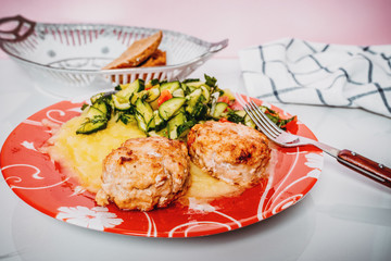 Meat cutlet with mashed potatoes and cucumbers