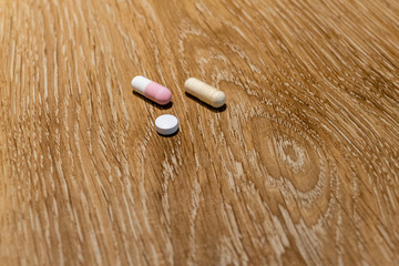 Capsules and pill on table