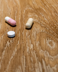 Capsules and pill on table