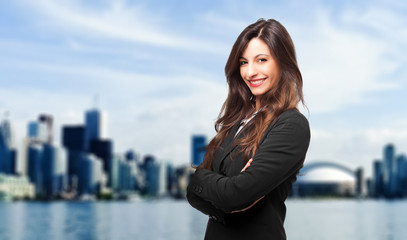 Business, young smiling businesswoman outdoor in a modern city setting