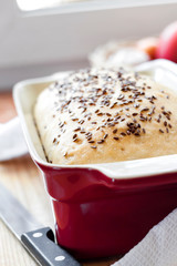 Homemade wheat bread with flax seeds in ceramic baking dish