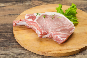 Raw pork bone steak over wooden