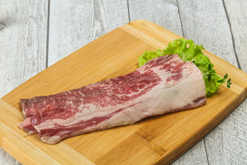 Raw beef bacon over wooden board