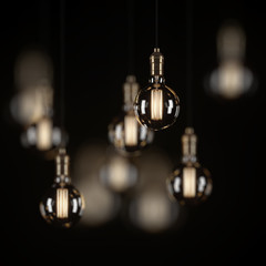 Decorative vintage light bulbs in Edison style on a black background. 3D rendering.
