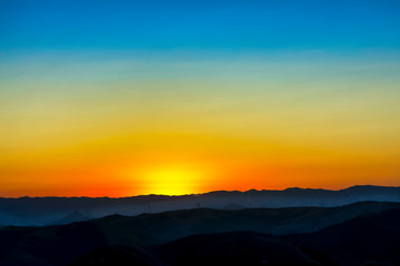 Sunrise over Silhouetted Horizon