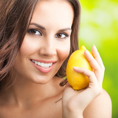 Young happy smiling woman with limon, outdoors