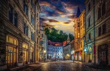 Fototapeta na wymiar View of the street Stritarjeva, evening city and Ljubljana's castle. Ljubljana, capital of Slovenia.