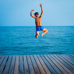 Fototapeta na wymiar summer fun - happy kids jump to the water