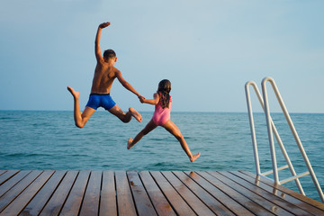 summer fun - happy kids jump to the water