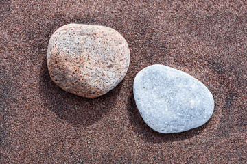 Beach red and yellow sand and sea stones