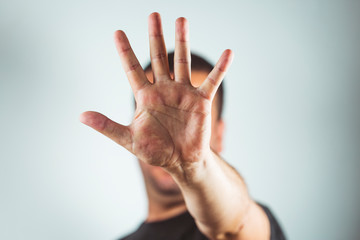 man showing hands and palm lines - Young man making stop gesture with his hand - concept of stop, strength