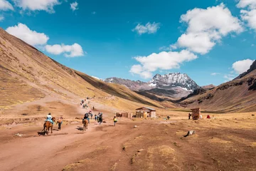 Fotobehang Vinicunca Tourists walking to Vinicunca Rainbow Mountain through stunning barren mountain landscape, Peru