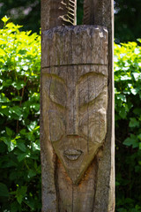 wooden symbol of a medieval warrior on nature in the foliage of trees
