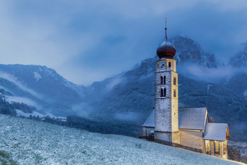 Fototapeta na wymiar Church of Saint Valentine on a snowy day, Seis am Schlern, Siusi allo Sciliar, Dolomites, Trentino-Alto Adige, Italy