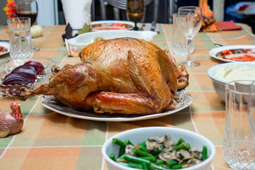 Roasted turkey on table at Thanksgiving