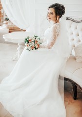 Beautiful brunette bride with stylish make-up in white dress